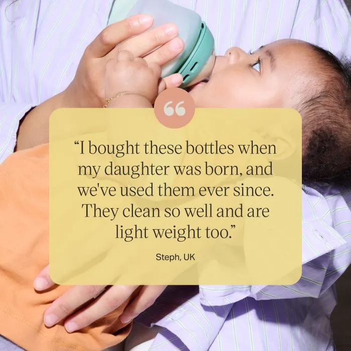 Woman feeding a baby using a silicone Natural Start bottle with text overlay of customer review