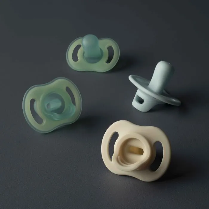 Four Ultra-light day and night soothers on a grey background.
