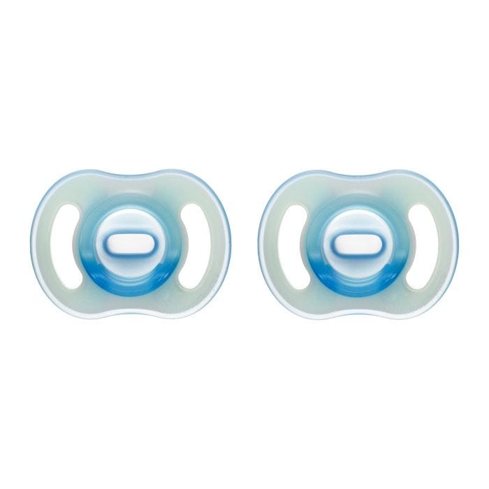 Ultra-light Night Glow pacifiers on a white background.