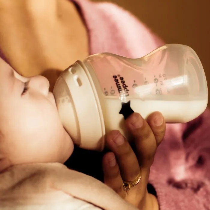 Woman feeding a baby using a Natural Start bottle
