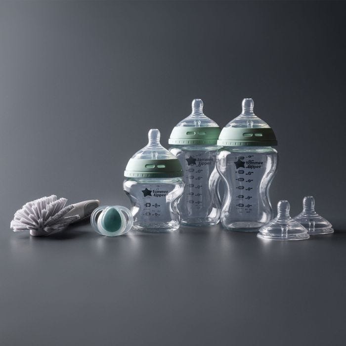 Glass baby bottles, newborn soother, teats and cleaning brush included.