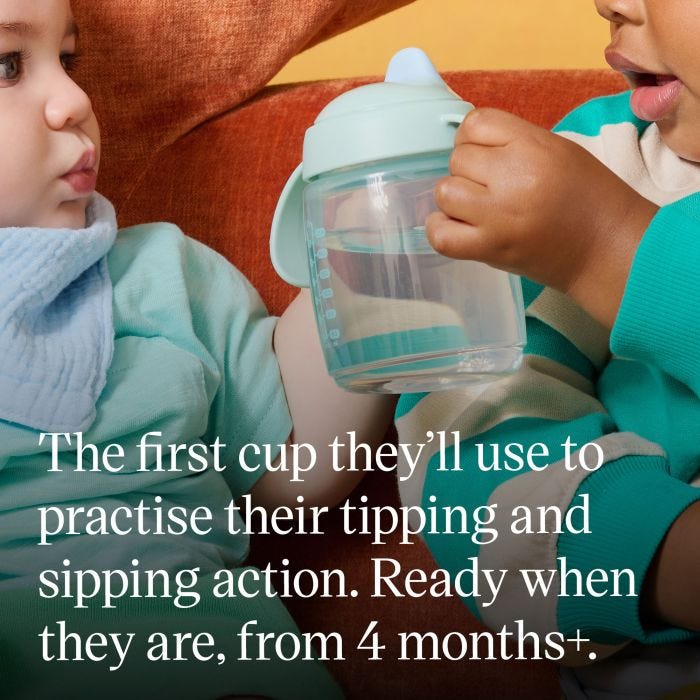 Toddler holding up a Starter Spout cup with product USP tagline below