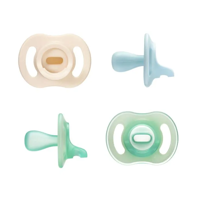 Two Ultra-light Stay Put and two Night Glow soothers on a white background.