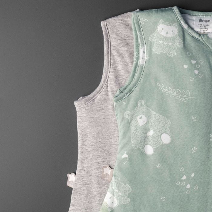 Two baby sleeping bags on a grey background