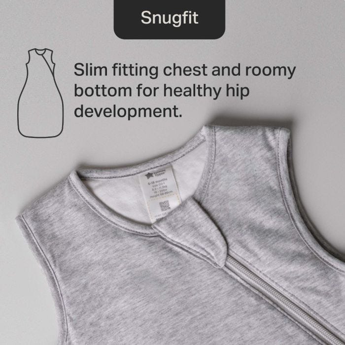 Grey sleeveless baby garment with a zipper, promoting "Snugfit" design. Features slim chest, roomy bottom, supporting healthy hip development. 