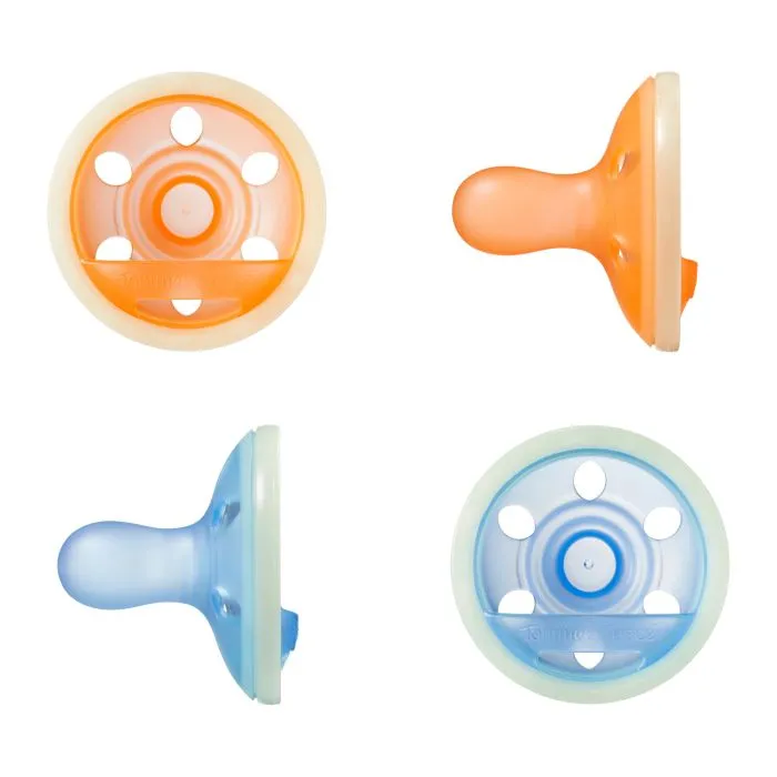 Breast-like night glow pacifiers on a white background