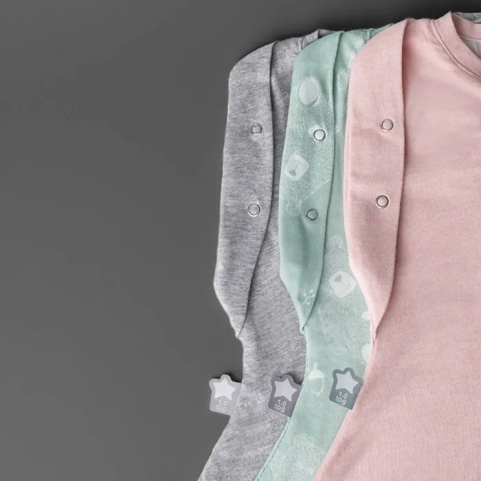 Three baby sleeping bags on a grey background