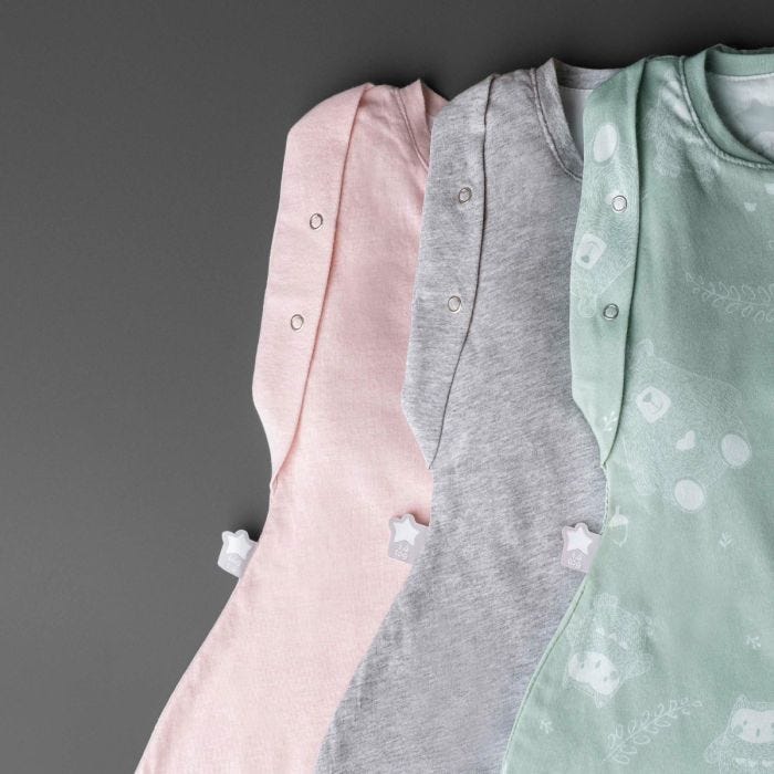 Three baby sleeping bags on a grey background