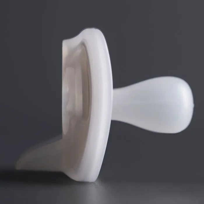 Close up of pacifier on a dark grey background