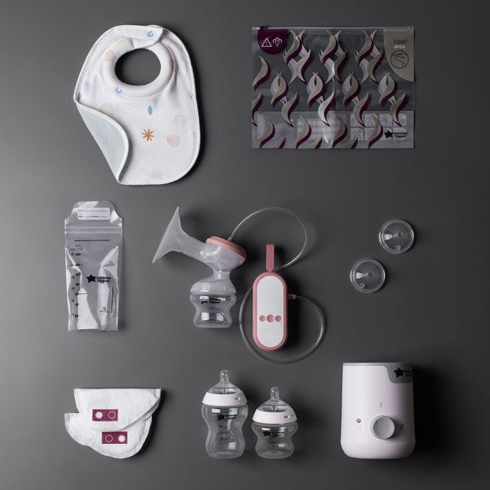 Flat lay of all Complete Breastfeeding Kit contents on charcoal background.