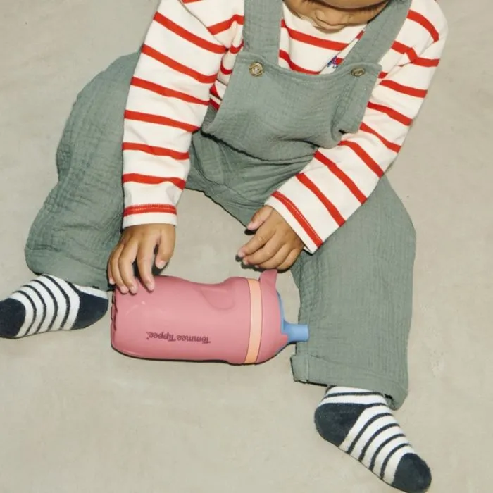 Image of a toddler sat on the floor playing with an Insulated Sporty Spout and Straw Cup