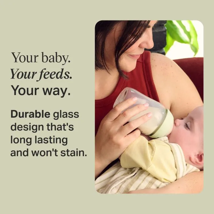 Woman feeding her baby using a Tommee Tippee Natural Start glass baby bottle with text stating "Your baby. Your feeds. Your way. Durable glass design that's long lasting and won't stain."