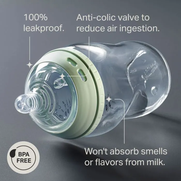 Natural Start glass bottle laying on its side against a grey background with pointers to the key product features