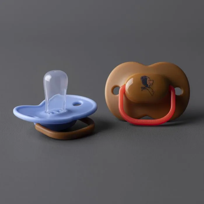 A blue and brown anytime soother laid out against a grey background