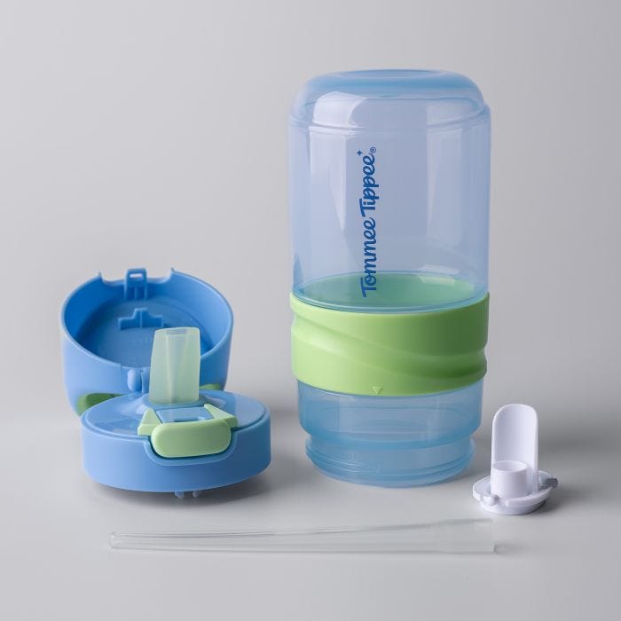 Blue on-the-go straw cup components laid out against a grey background