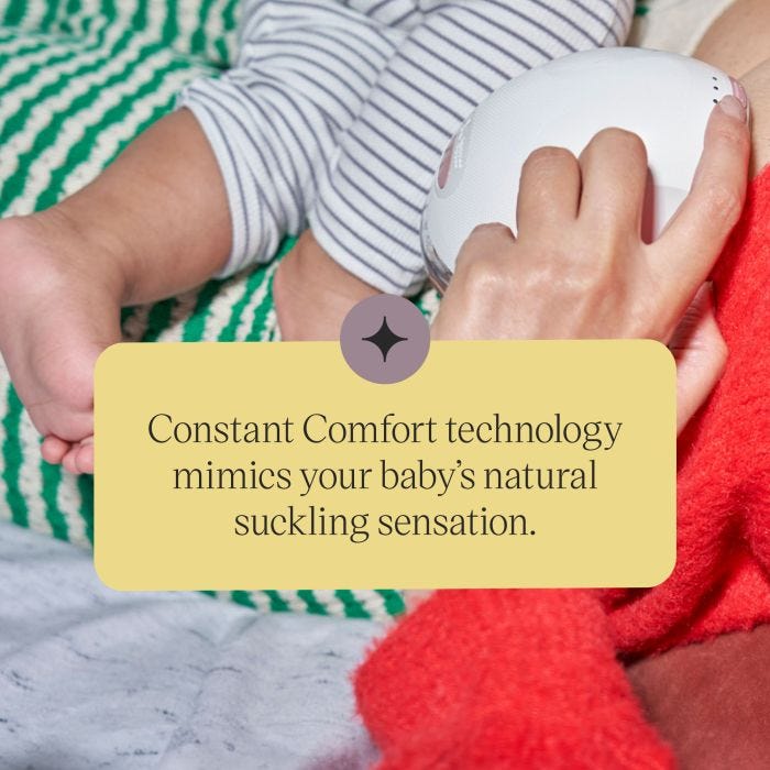 Parent using our Wearable Breast Pump while holding a baby.