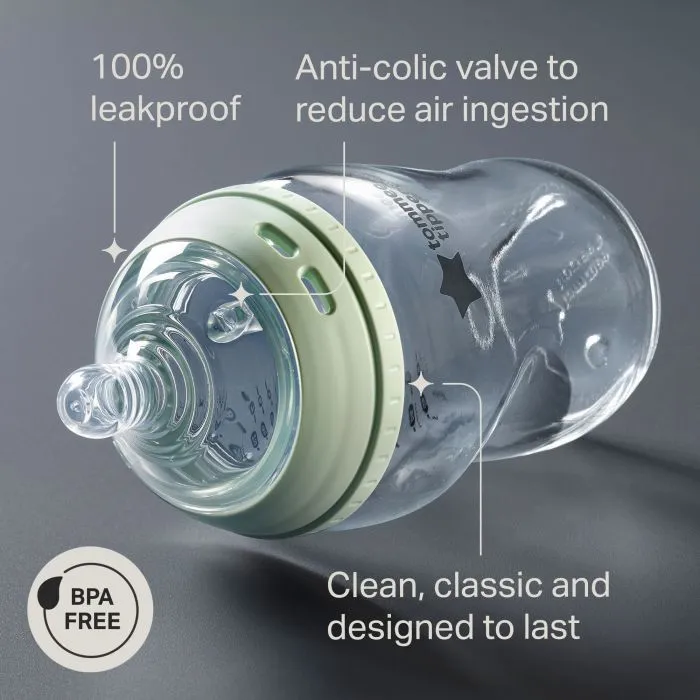 Natural Start glass bottle laying on its side against a grey background with pointers to the key product features