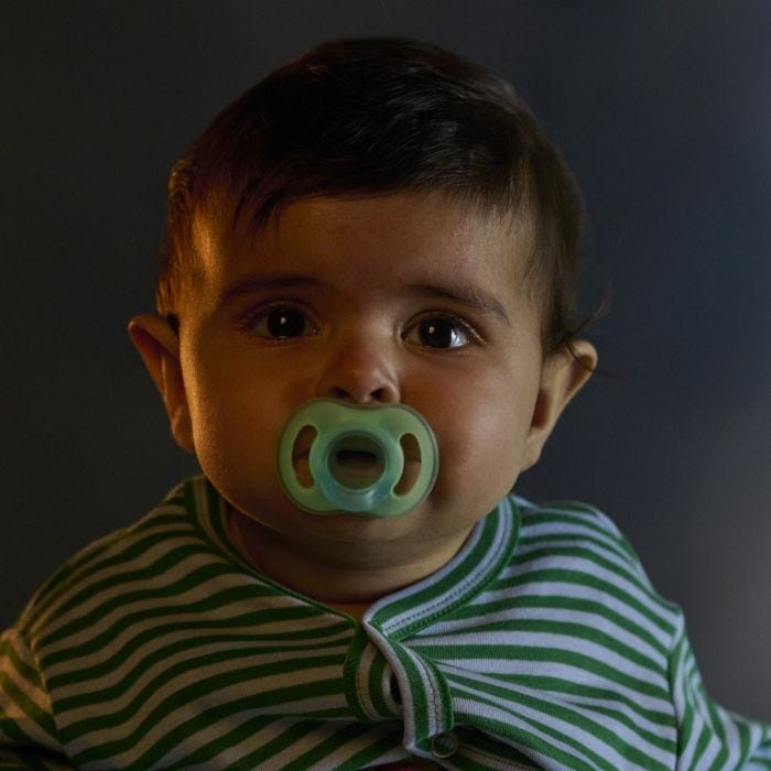 Baby with a glow in the dark pacifier.