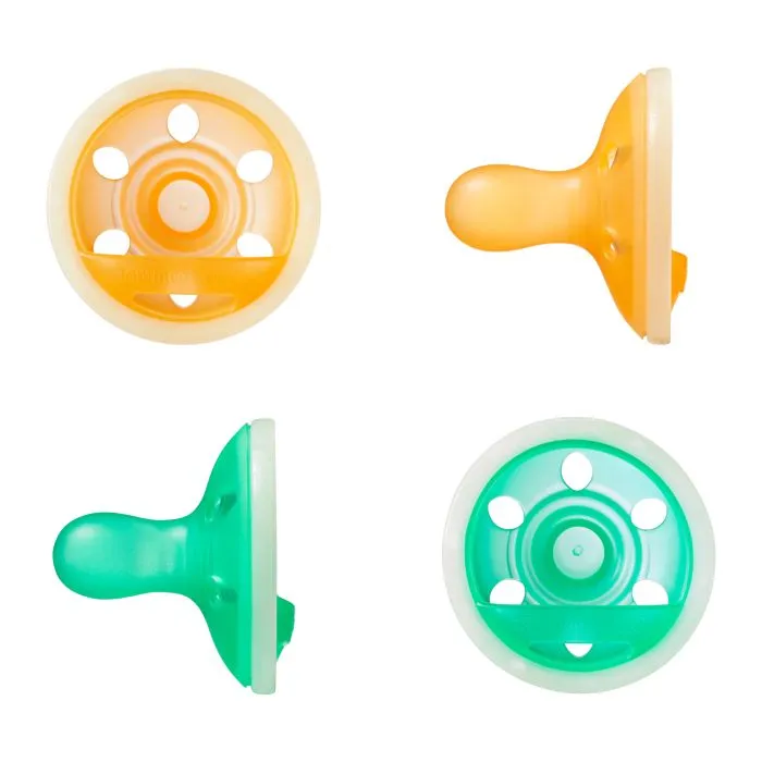 Breast-like night glow pacifiers on a white background