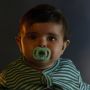 Baby with a glow in the dark soother.
