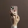 Hand holding a phone with StayPut Pocket™ attached.