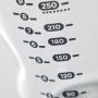 Close up of measurement markers on a glass baby bottle.