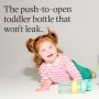 Toddler laying on the floor playing with an on-the-go straw cup with text overlay of product USP
