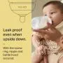 Baby drinking from a Natural Start baby bottle