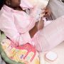 mage of a woman sitting on a sofa using a double electric breast pump