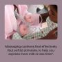 Parent expressing with our double electric breast pump while holding baby.