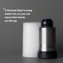 Thermal flask next to frosted base against a grey background with product USP tagline