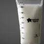 Filled breast milk storage bag on a charcoal background.