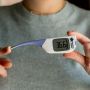 Flexipen thermometer being held and the tip is being pushed down to show how flexible it is.
