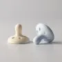 Breast-like soothers on a grey background.