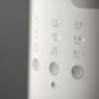 Close up image of the buttons on a Multiwarm bottle warmer against a grey background