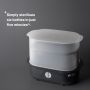 Black steam steriliser against a grey background with product USP tagline