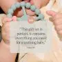 Baby chewing on the teeter ring with a parent review.