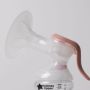 Side shot of a manual breast pump horn and ergonomic handle.