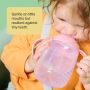 Toddler drinking from a pink Starter Spout cup with text overlay of product messaging