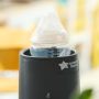 Baby bottle placed inside an Easiwarm bottle warmer on a kitchen counter