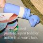 Blue on-the-go straw cup open and on its side on a rug with product USP tagline below it