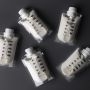 Five sealed breast milk pouches containing milk ona  dark grey background.