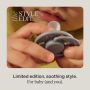 Close-up of a baby holding a limited edition soother near their mouth.