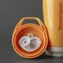 Insulated sporty spout cup base with lid next to it showing the two-piece valve against a dark grey background