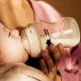 Woman feeding a baby using a Natural Start bottle