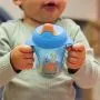 Little boy holding his blue Trainer Sippee