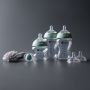Glass baby bottles, newborn soother, teats and cleaning brush included.