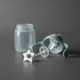 Green starter straw cup against a dark grey background disassembled to show all the pieces