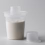 Dispenser containing formula on a light grey background.
