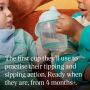 Toddler holding up a Starter Spout cup with product USP tagline below